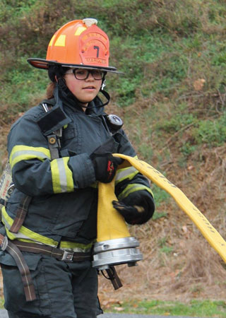 (1) A junior firefighter from the New Egypt (NJ) Volunteer Fire Company pulls hose. <i>(Photos by Paige Kahler, Five Points Photography.)