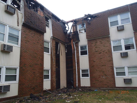 (3) View of side D of the fire building and side B of the attached exposure. Fire extended past the fire wall, but it was stopped in the immediate area. <i>(Photos by Robert Cembor.)</i>