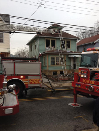 (5) After stream placement, setting up aerials and ladders is the next best tactic to implement. They improve firefighter safety and increase the chance for survival. <i>(Photo by Joel D. Bain.)</i>