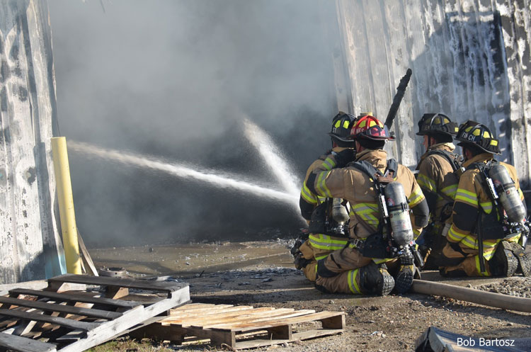 Fire crews operate defensively at this fire at a pallet company