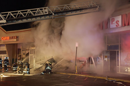 (2) Large-caliber handlines were used to hit the fire from the front and to control extension into the Bravo exposure.<i> (Photo by Bill Tompkins.)</i>