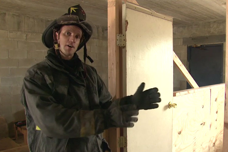 Firefighter demonstrating how to remove a door