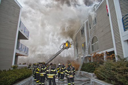 (6) The tower ladder is operated to the top-floor windows, knocking down the gypsum ceiling and exposing fire in the attic space. 