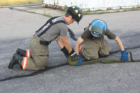 (3) The firefighter is beginning the “donut” roll.