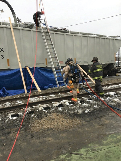  (3) Confined space technicians make their way to the top of the railcar for entry, patient packaging, and removal. (Photo by Tom Johnson.)