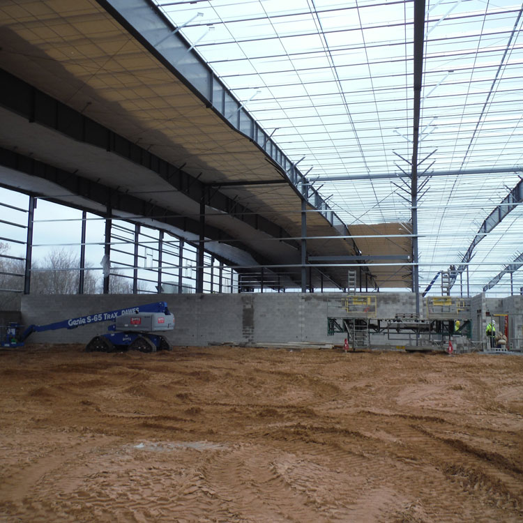 Part of the interior of the same building with the steel banding and membrane that will support the insulation below the roof.