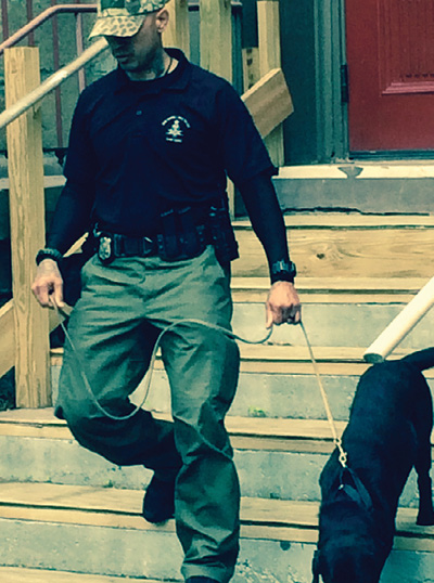 (1) A bomb squad dog clears the fire department staging area at a civil protest. (Photo courtesy of Frank Ricci.)