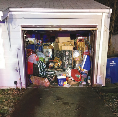 (1) Garages are commonly used for impromptu storage units and can contain heavy fire loads. This not only makes the fire content heavy but also can make access extremely difficult. (Photo by author.)