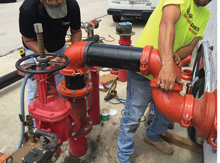 (15) Sprinklermatic pipe fitters connect the pump’s intake to Miami Dade’s training facility’s water main and plumb the pump’s discharge piping directly to the training tower’s standpipe system. (Photos by Mike Posner.)