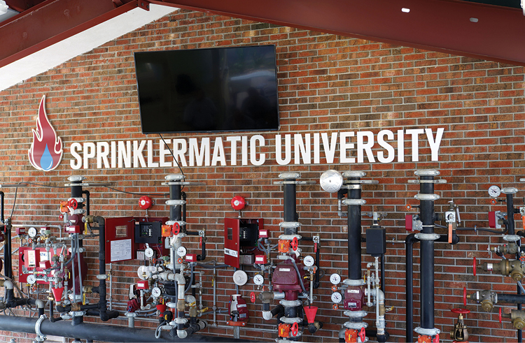 (19) An array of systems and valves at Sprinklermatic University. (Right to left) a 13-D system; a 13-R system; an assortment of pressure-reducing and conventional hose outlets and floor isolation valves; a modern sprinkler riser with a flow switch and a two-inch drain line; an “old school” sprinkler riser with an alarm check valve, a retard chamber, and a water motor gong; a dry pipe valve and riser; a single-interlock preaction system; a double interlock preaction system; and a “Fire Cycle” sprinkler system. (Photo by Eric Goodman.)