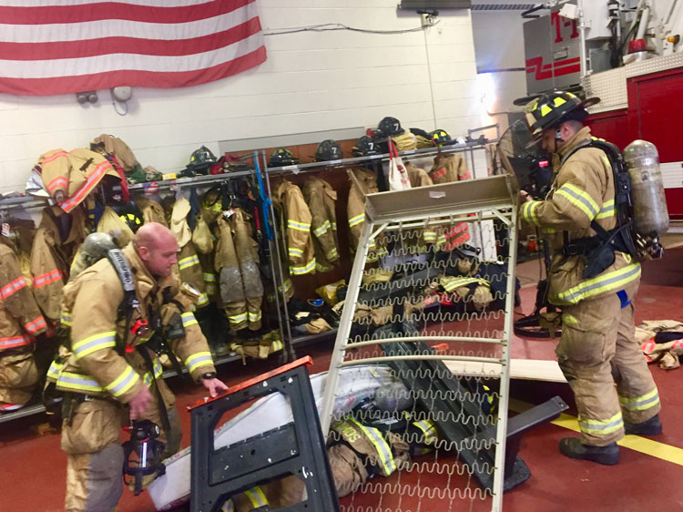 Members create some pressure on the down firefighter