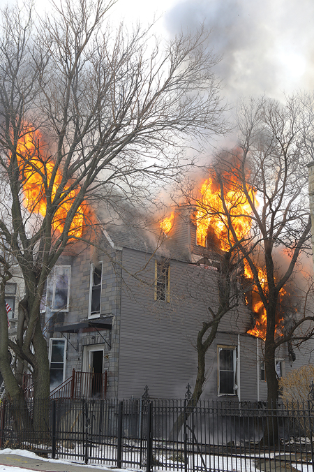 (1) Conditions on arrival: heavy fire in sectors A, C, and D on floors two and three and the attic. (Photos by James Regan.) 