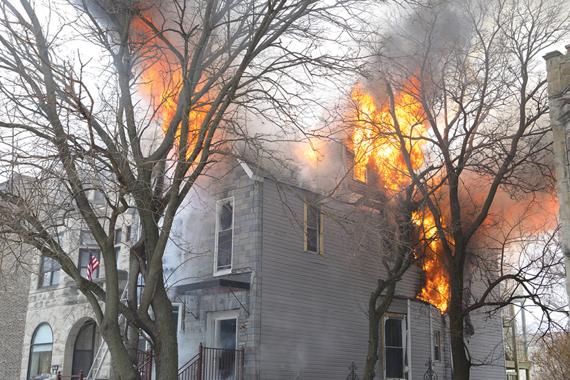 (2) Conditions on arrival: heavy fire in sectors A, C, and D on floors two and three and the attic. (Photos by James Regan.) 