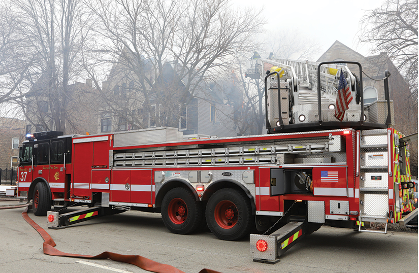 (8) Tower Ladder 37 moves in for hydraulic overhaul and removes tree branches for access.