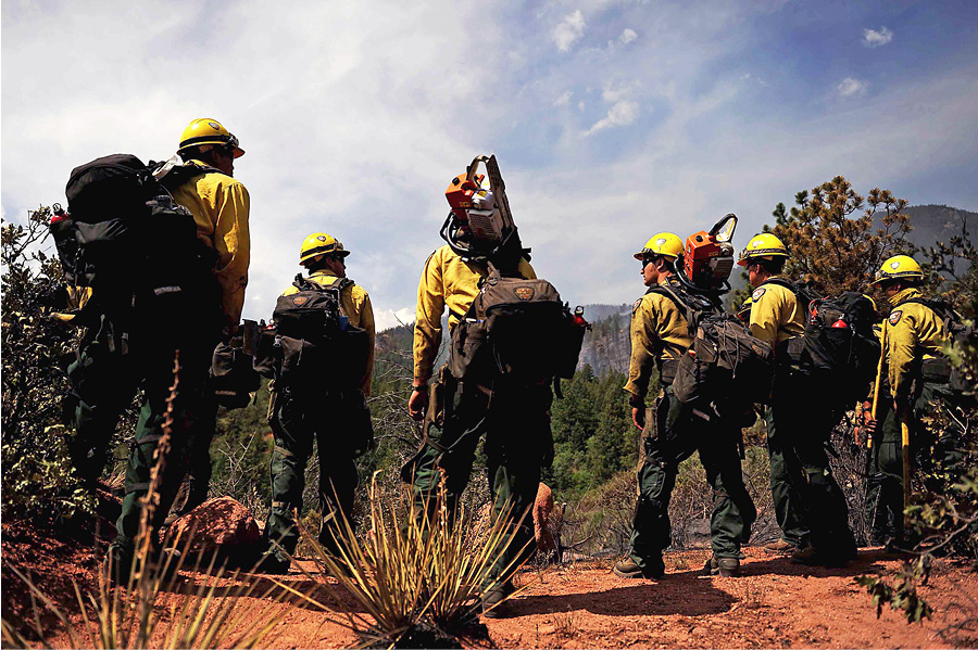 Members of the Hotshots from Vandenberg (CA) Air Force Base prepare to cut a fire line in the Peregrine neighborhood of Colorado Springs, Colorado, in 2012.