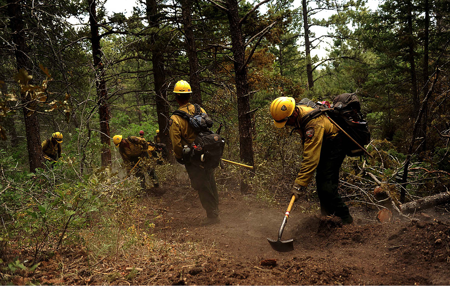 Firefighters from the Vandenberg (CA) Air Force Base Hotshots cut a fire line in the Mount Saint Francois area of Colorado Springs, Colorado, while helping to battle several fires in Waldo Canyon in 2012.