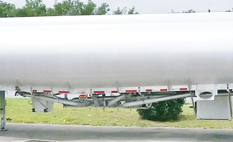 The belly piping (wet lines) of a four-compartment tanker trailer. 