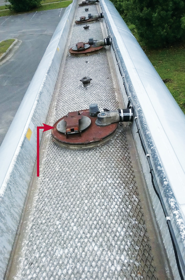 On the manhole, clockwise from left (arrow) are the dome hatch, the Scully device, and the vapor valve. 