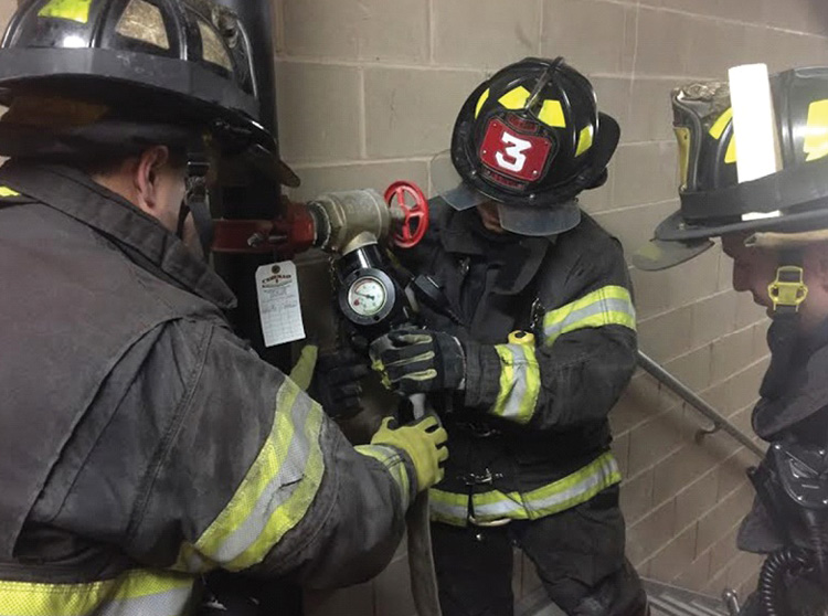 Firefighters check and inspect the standpipe during a routine call. This is a good opportunity to become familiar with the location of the standpipe and practice the standpipe hookup. 