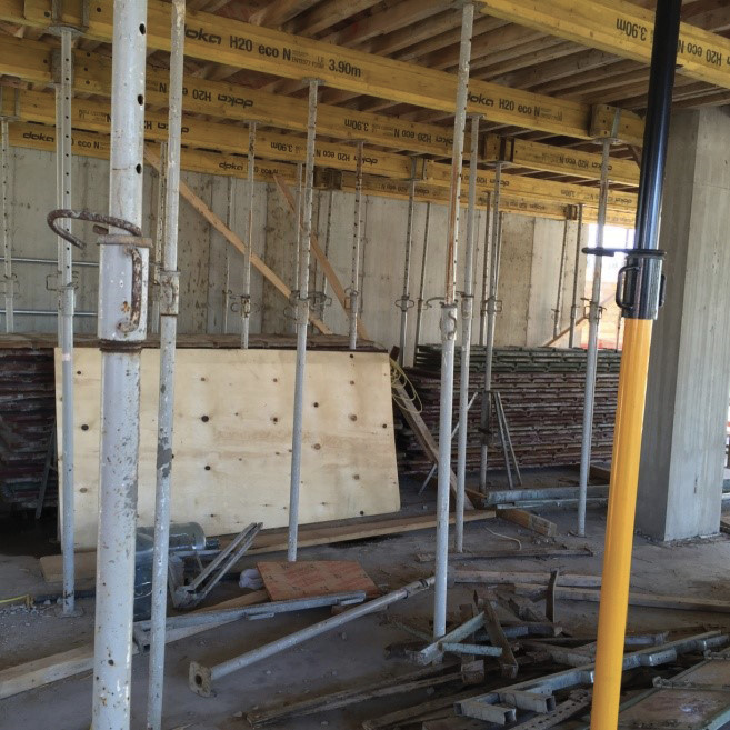 The staging area for shoring on the floor below the recently poured floor.