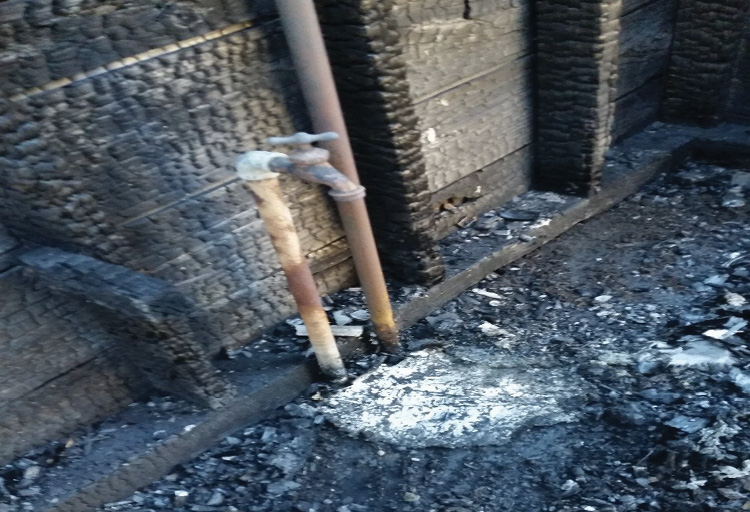 The white remains of the plastic bag that contained the rock salt. Note that the area around the plastic bag is charred.