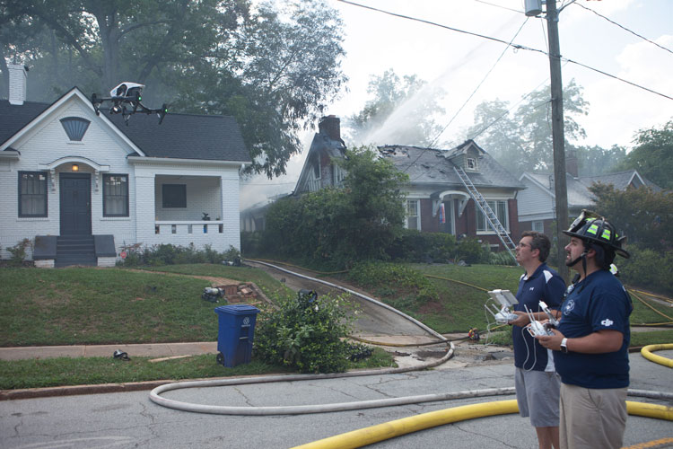 Man in fire helmet pilots drone