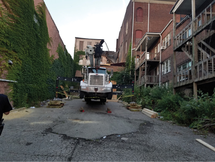 A postincident view of the 50-ton crane on side C. Note the terrain and the effort required to level the crane for operations. In the background, the boom of the 120-ton crane positioned at the A side is visible. (Photo by Jeffrey Yates.)