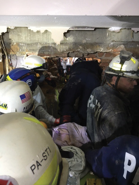 After the secondary collapse, a rescuer aided by crews accessed the victim through the B-side exposure. (Photo by Joseph Janosko.) 