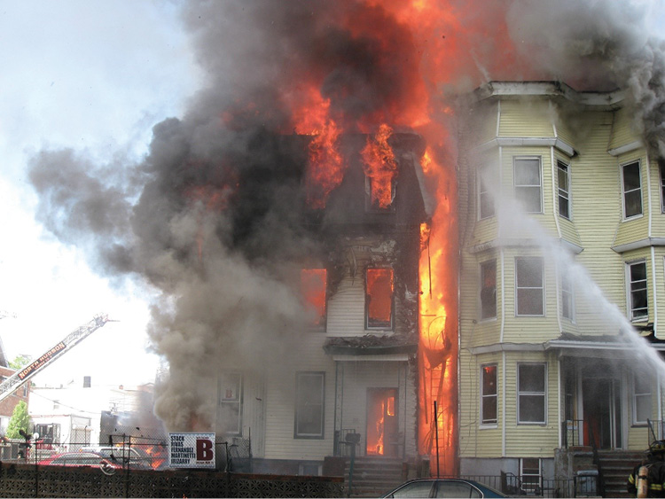 (2) This fire started on the outside as a vehicle fire and spread by asphalt siding into the building on the left. It is now involving the exposure. What risks will we take here?