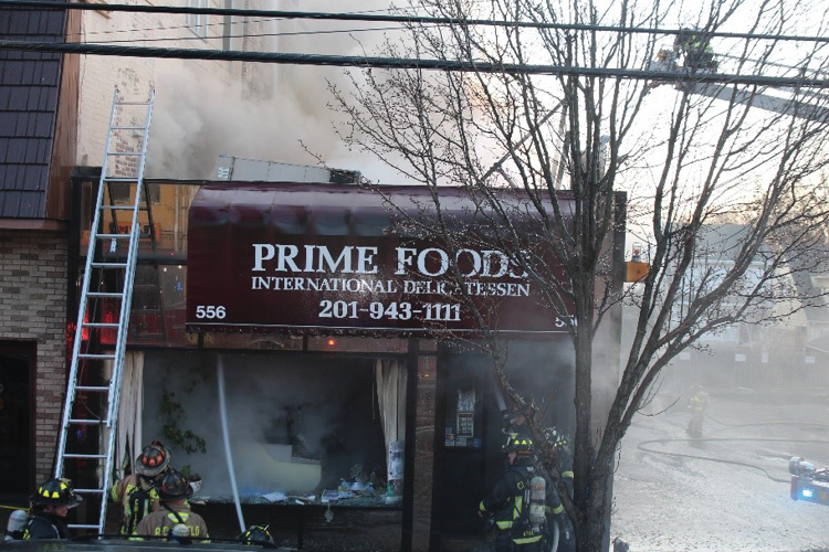 (4) One look at the heating, ventilating, and air-conditioning unit sinking through the roof is a cue that you should pursue a defensive mode of operation. Although it looks like this operation is semi-defensive in nature (semi-defensive is NOT a strategic mode), the lines are certainly in the collapse zone, and the line in the doorway on the right is in a critically unsafe position.