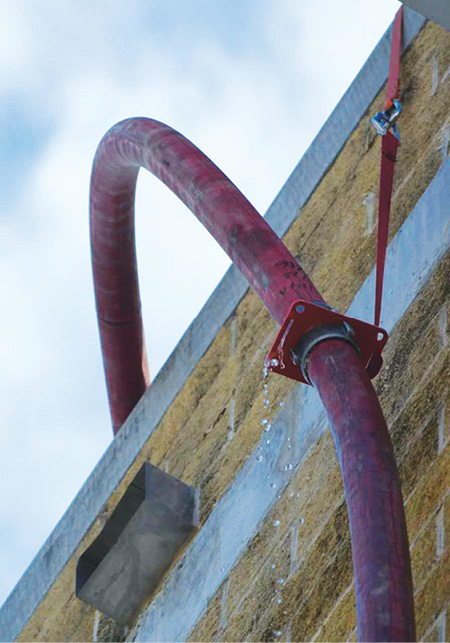 (25) A more distant view of the suspension plate showing how the hose is supported, which allows the hose to bend from the side of the building to the roof without kinking. 