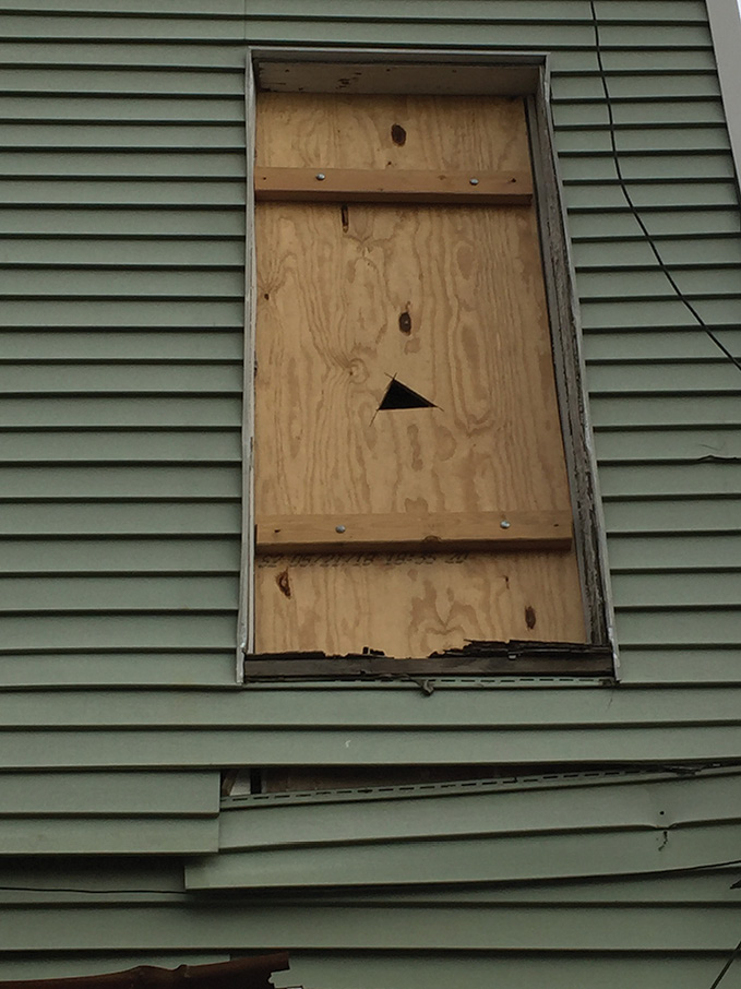 (9) A HUD window close up. Use the point of the halligan to split the wood or use a saw to cut the bolts.