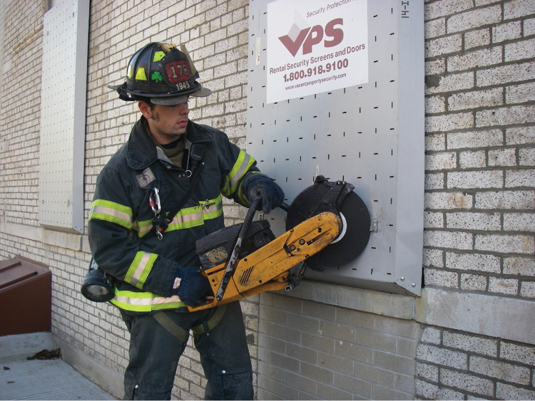 (16) A firefighter uses a saw to cut the bolt head on a cable-type VPS window guard.