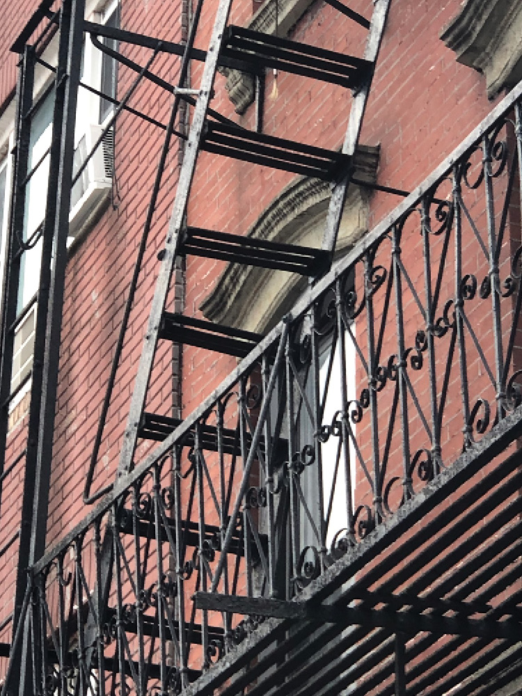 Corrosion has likely destroyed the connection between the fourth step and one of its metal stringers. If this connection is bad, it’s very likely there are other corrosion problems necessitating a closer inspection of the entire fire escape. 