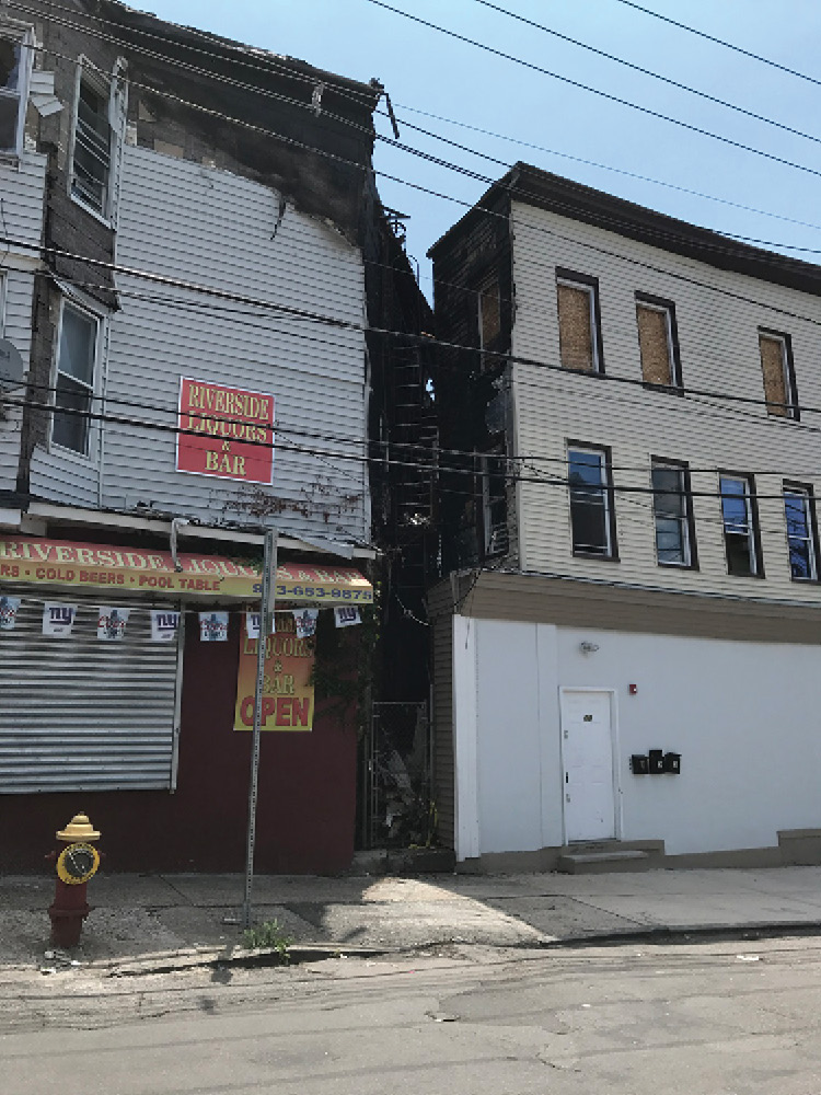 Typically, fire escapes are on a street side of a building or rear yard. This fire escape is in a narrow alley between two structures. The fire originated in the building on the left with the fire escape. Fire on the building’s exterior can cut off egress paths such as this one quickly. 