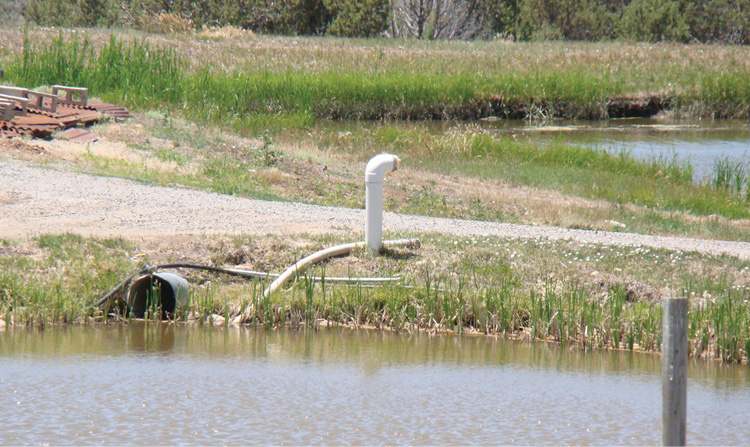 The dry hydrant installed at this pond provides a static water supply for fire suppression.