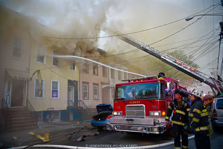 Fire trucks at row house fire