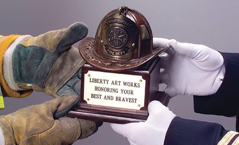 Liberty Art Works’ BRONZE LEATHER HELMET AWARD (in black or brown patina) is mounted on a four-inch walnut base is highly detailed with stitching, reflectors, and scrollwork.