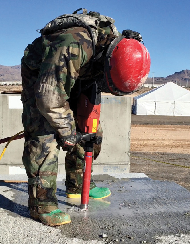 A core drill creates an inspection hole for a gas monitor and search camera.