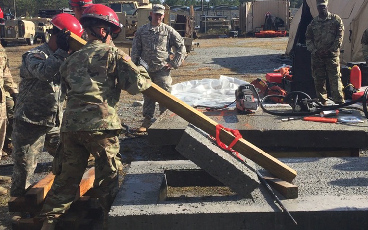 ) Rescuers lift the four- × four-inch lumber like a lever to remove the beveled concrete plug. (17) Task force members use a core drill to cre