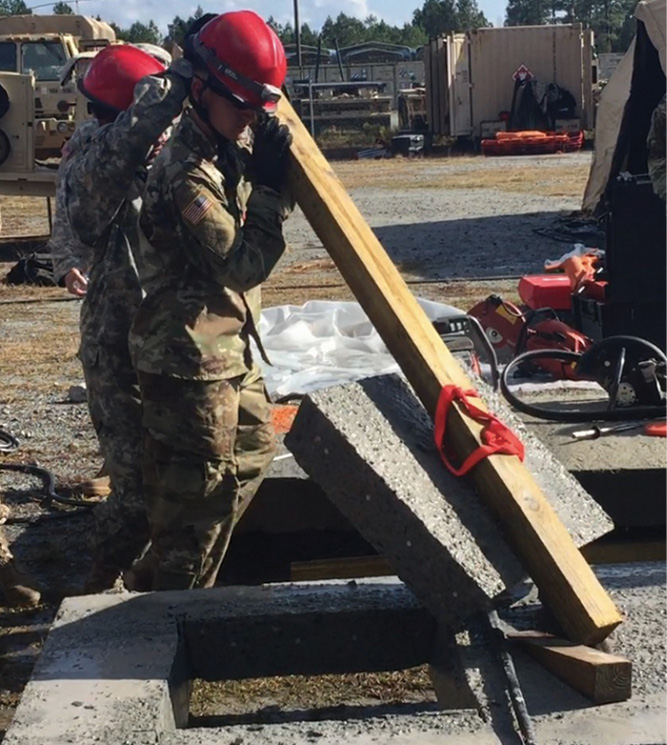 Rescuers lift the concrete away from the access hole.