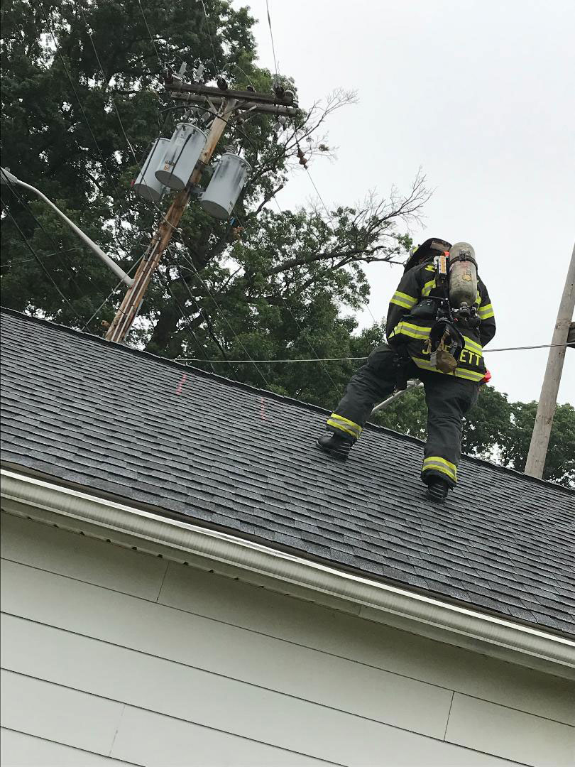 A firefighter using the prop on a roof