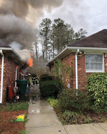 (3) The transitional attack on the garage through the B-side window.  (4) Engine 9’s crew advances an attack line into the door on the B side of the garage just prior to the structural collapse.