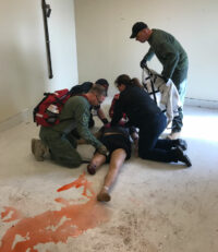 Responders attend to a victim during training.