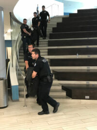 Law enforcement officers transport victims during training.