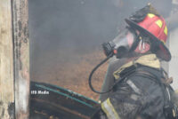 A firefighter in SCBA working at the fire scene