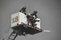 Firefighters in a tower ladder bucket