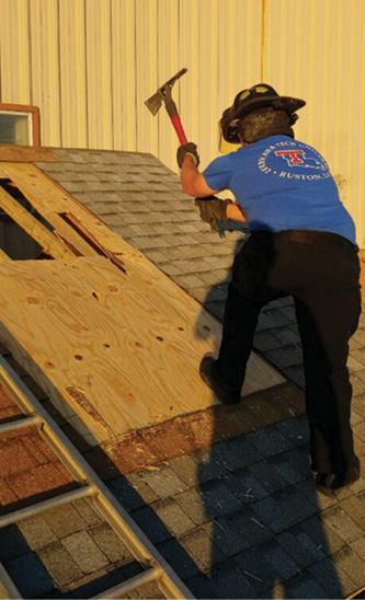 A firefighter trains on vertical ventilation using an ax on a roof prop built to construction specs. We train with hand tools because a hand tool will always “start,” you can sound with the same tool, and you can truly understand what you’re supposed to feel when you hit a stud vs. “good” wood. (Photos courtesy of Ezekiel Webb.)