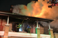 Firefighters open up ceiling at the fire scene.