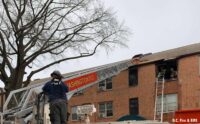 Firefighters on a aerial device at an apartment fire